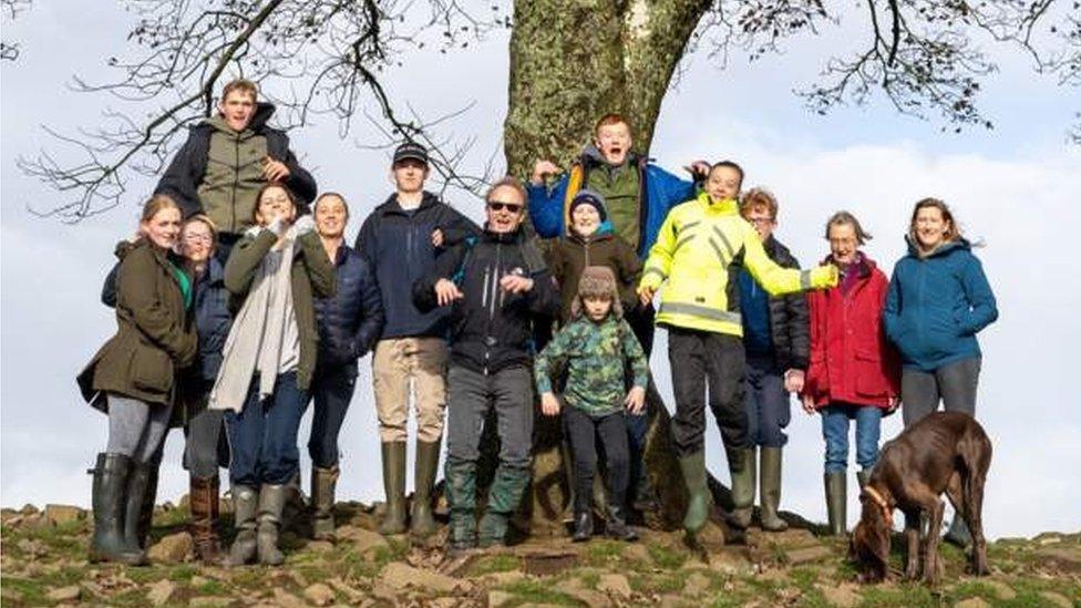 Miles Courage with friends and family at the tree in 2022