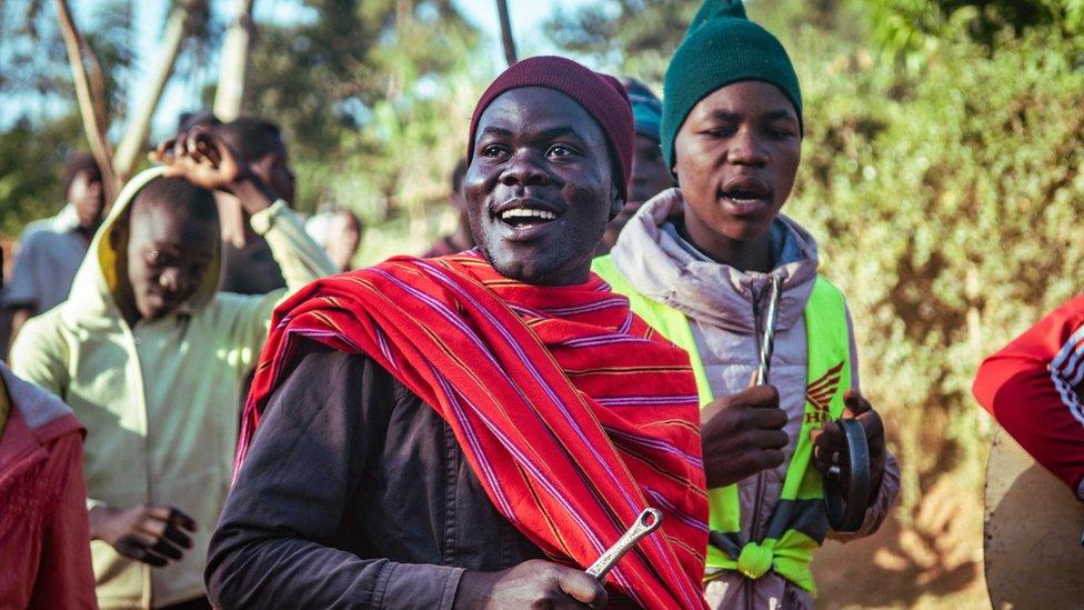 People in western Kenya arriving to watch a bull fight playing musical instruments