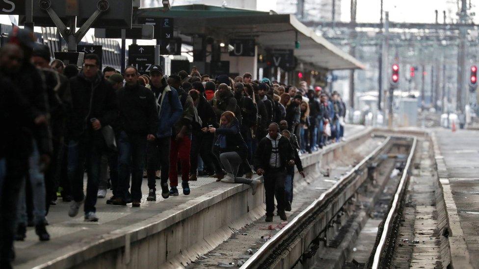 Commuters walk on a platform at Gare de Lyon train station in Paris during a nationwide strike