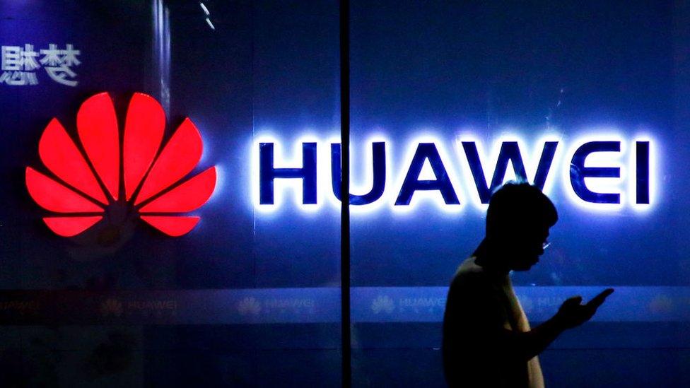 A man walks past a Huawei store in Beijing