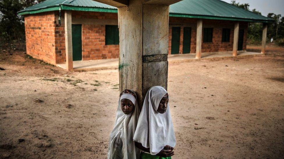 Two Fulani girls at an empty school playground.