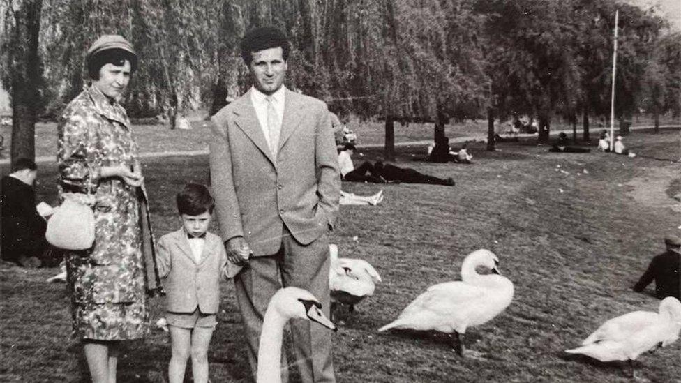 Mum and dad with son at riverbank