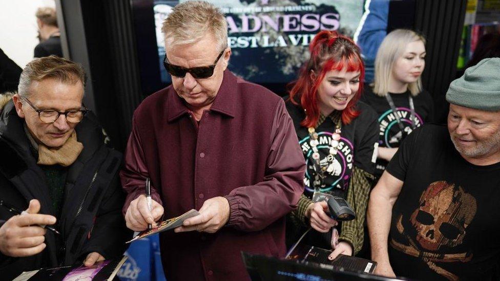 Madness signing autographs at the reopening of the HMV store on London's Oxford Street