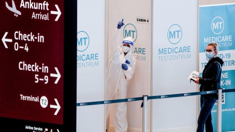 Medical staff in front of coronavirus test station at the Berlin Brandenburg Airport Terminal 1, Schoenefeld, near Berlin, Germany, 26 March 2021