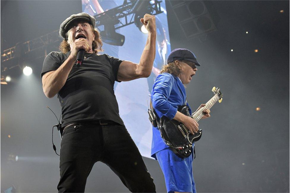 In this 17 February 2016 file photo, Brian Johnson, left, and Angus Young perform with AC/DC on the Rock or Bust Tour in Chicago.