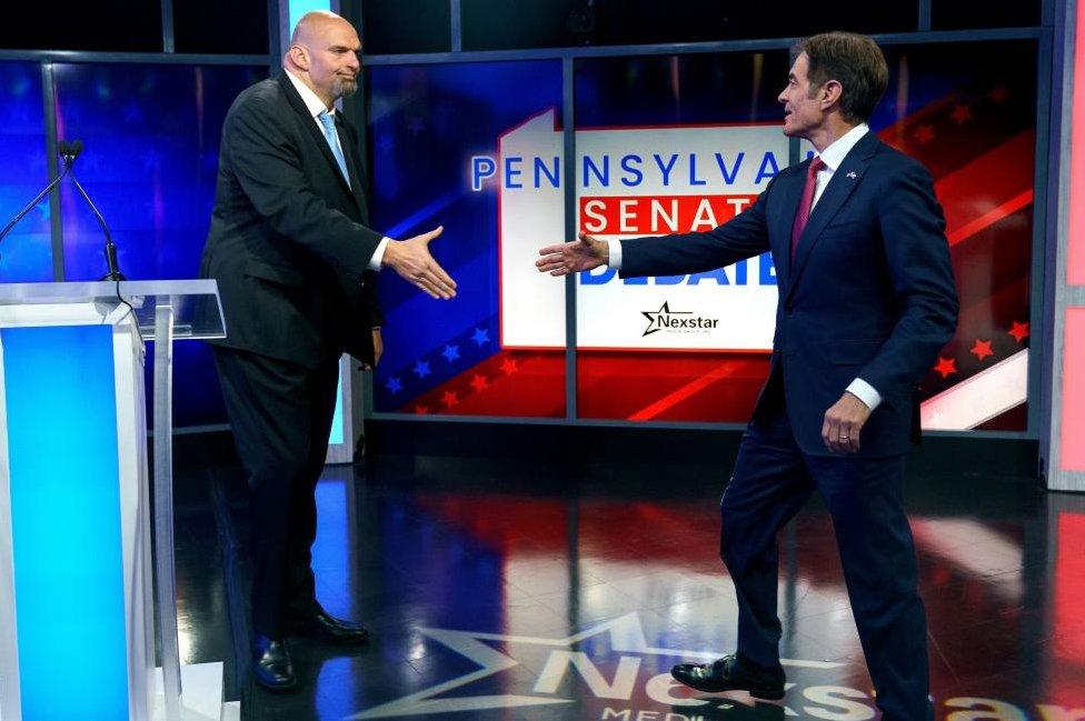 Democratic candidate Lt. Gov. John Fetterman and Republican Pennsylvania Senate candidate Dr. Mehmet Oz shaking hands prior to their 25 October debate