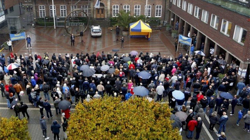 A crowd gathers as Sweden Democrat parliament member Kent Ekeroth speaks during a demonstration to strengthened border controls held at the Radhustorget Square in Trelleborg, Sweden, on 17 October 2015.