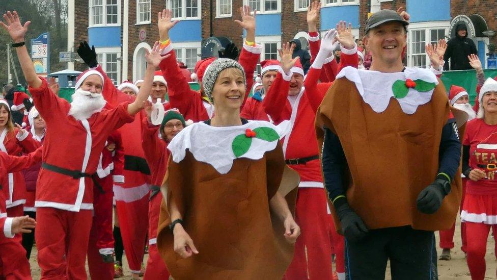 People in christmas pudding costume