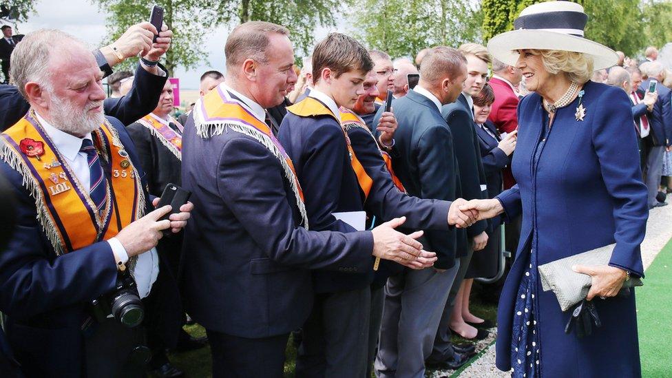 The Duchess of Cornwall shakes hands with Orangemen at the Ulster Tower in Thiepval