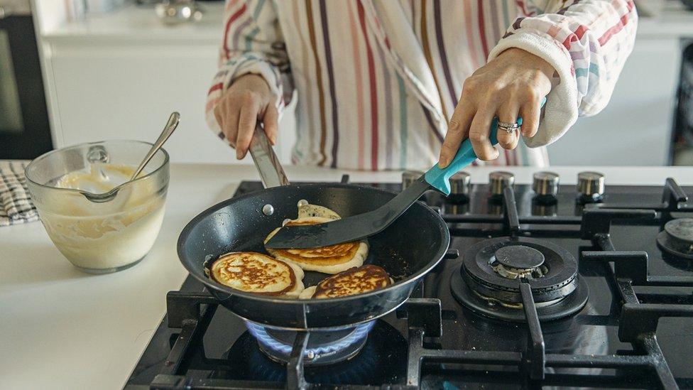 Person using gas cooker