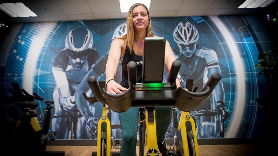 A woman on a spin bike