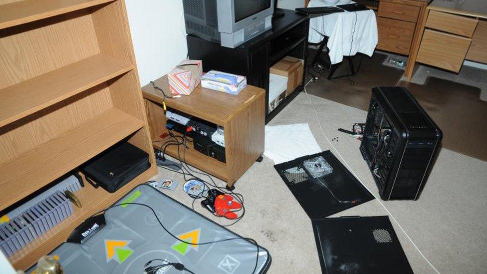 A dance mat and electronic equipment strewn across a bedroom floor