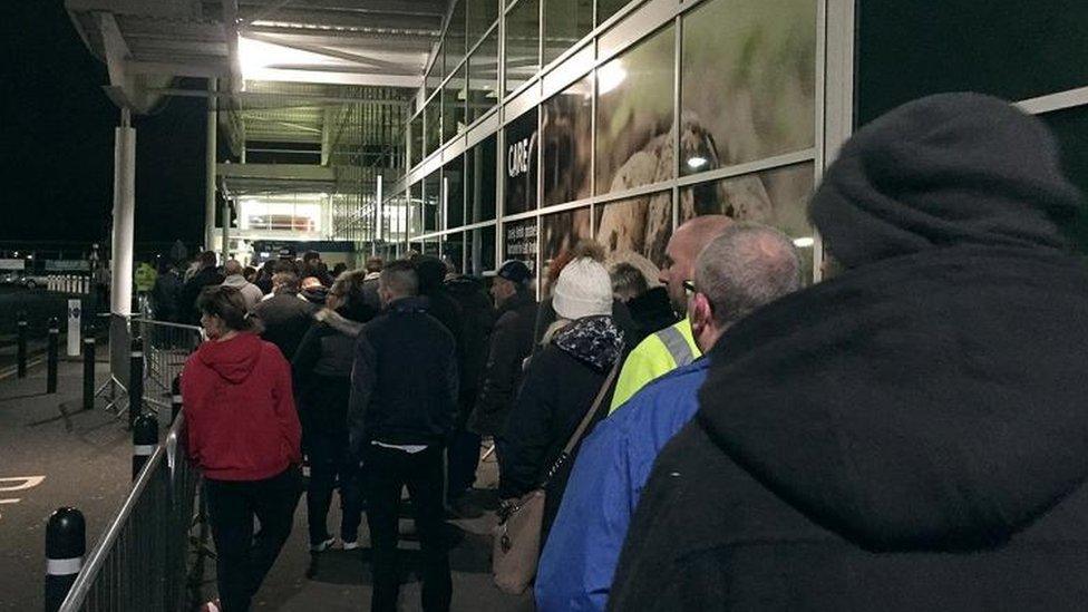 Shoppers queuing outside a Tesco