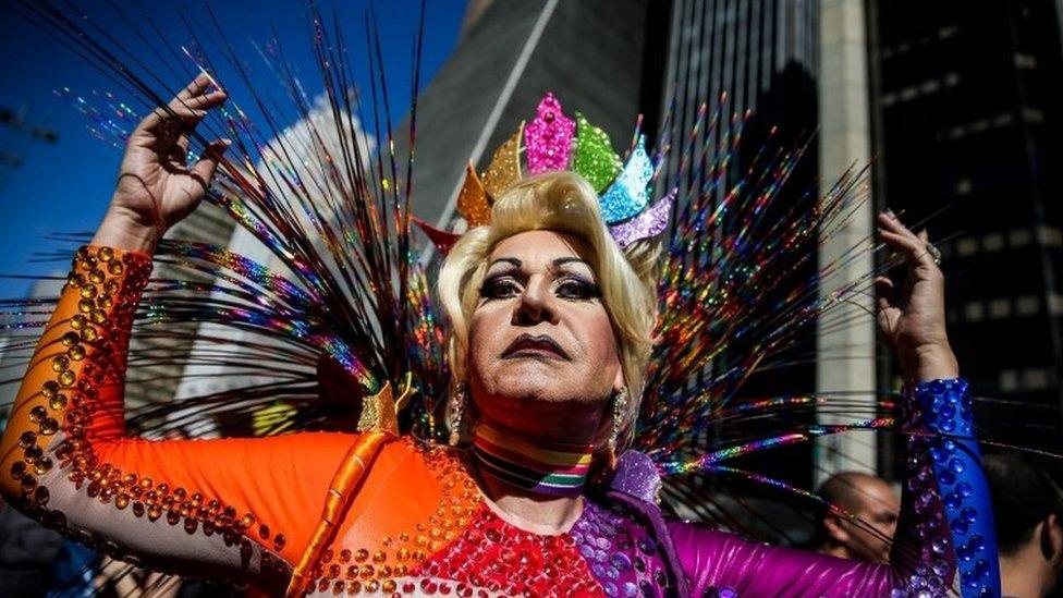 A participant joins revellers at the 21st Gay Pride Parade in Sao Paulo, Brazil, 18 June, 2017