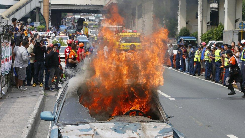 A dilapidated car is set on fire to simulate damage from a strong earthquake during a Metro-wide shake drill to test various government agencies" response in the event of a real one Wednesday, June 22, 2016