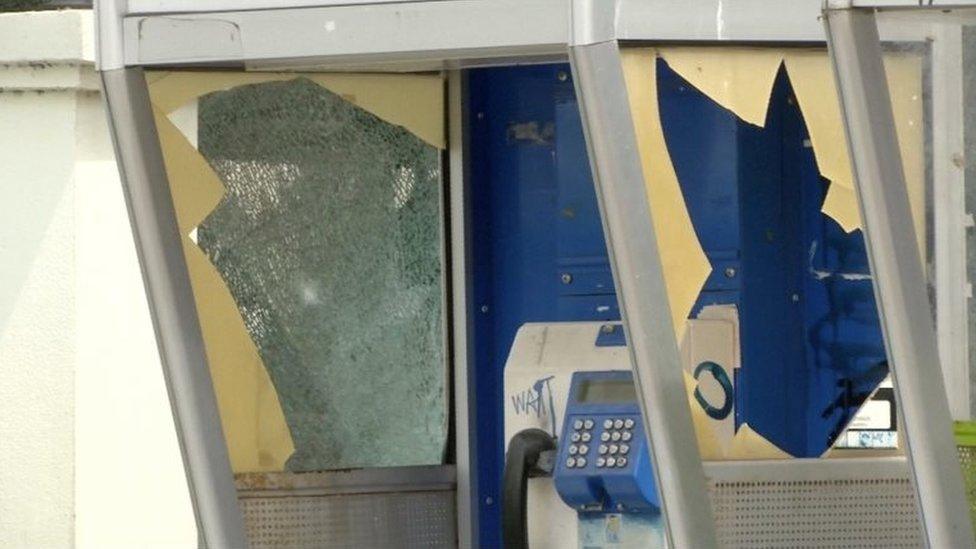 A damaged public telephone booth is seen at the site of a bomb blast in Hua Hin, south of Bangkok, Thailand