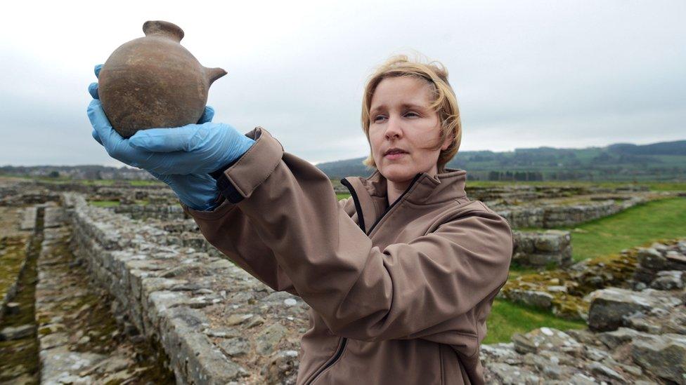 Curator of Roman collections Frances McIntosh, holding an infant's feeding bottle