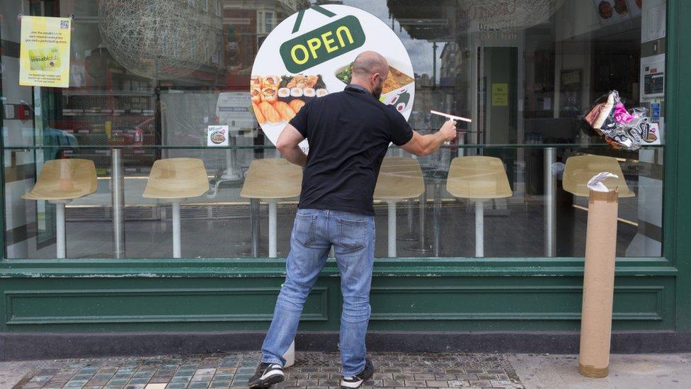 Man cleans restaurant window