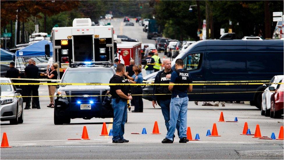 Police work at the scene where Ahmad Khan Rahami, the suspect in a 17 September explosion in New York City and a second bombing later that evening in New Jersey, was arrested following a shootout with police in Linden, New Jersey,