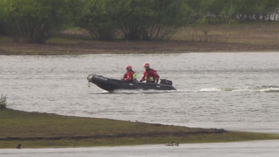 Emergency services searching the lake