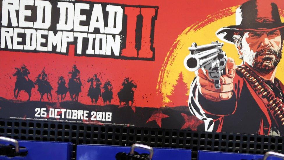 An image shows advertising material for Red Dead 2 on display in Paris