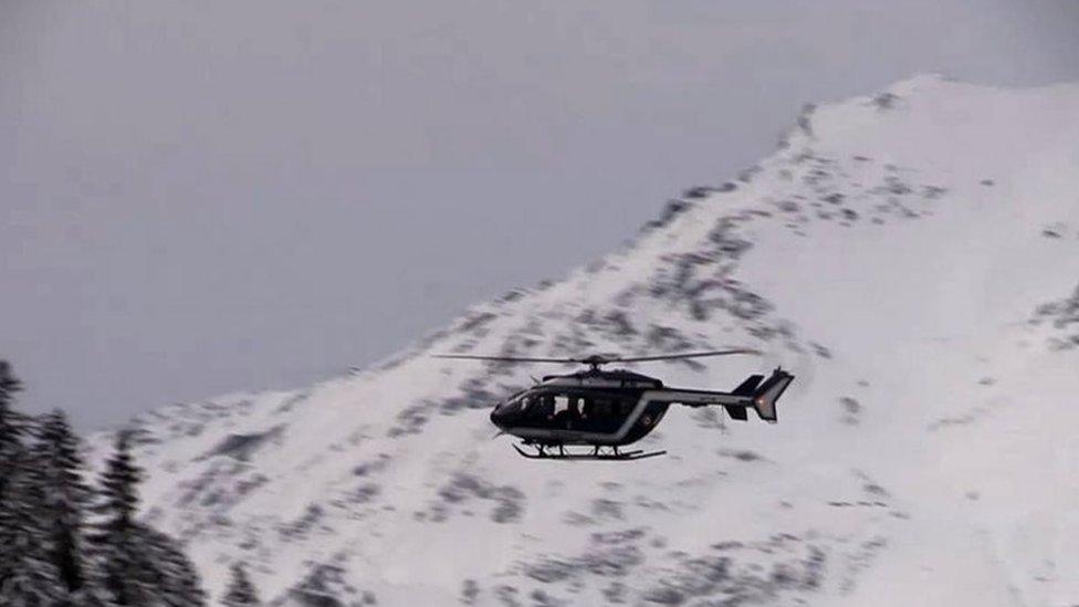 A helicopter flies over the area where an avalanche killed five French Foreign Legionnaires. Photo: 18 January 2016