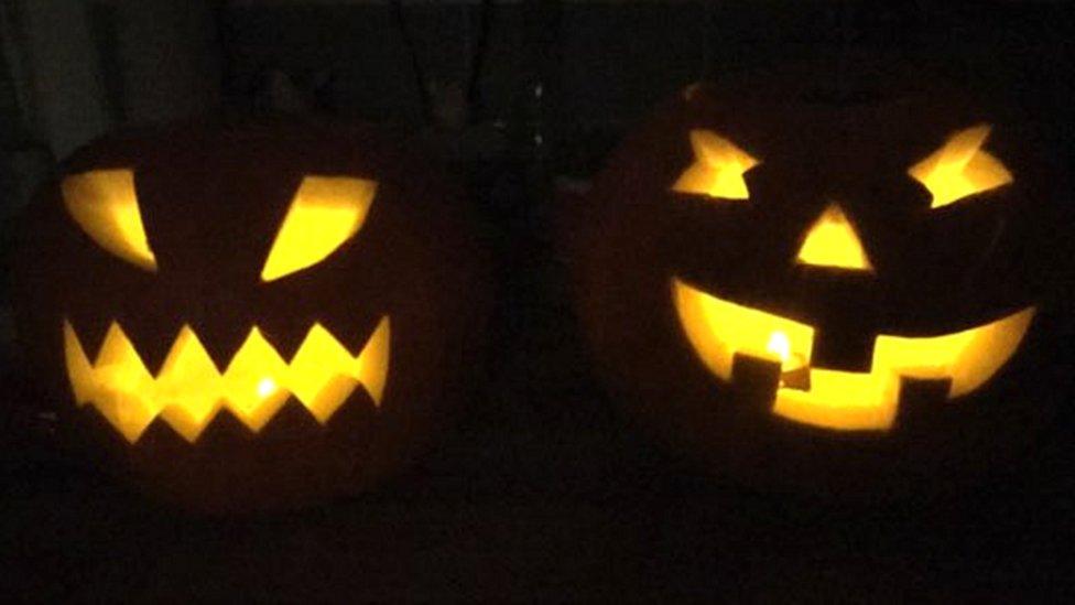 Faces carved into two pumpkins