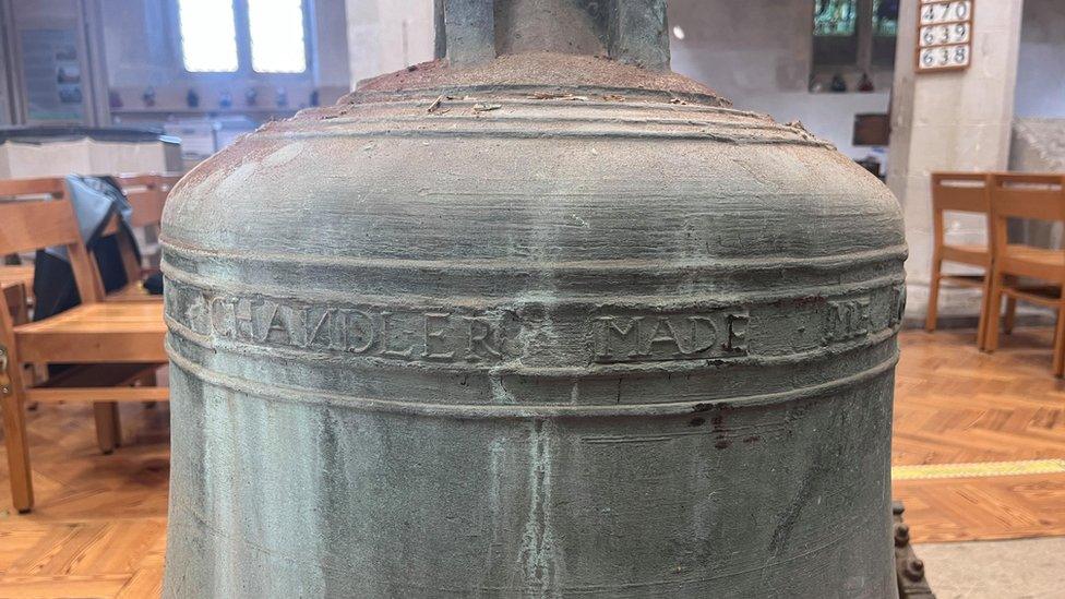 A bell inscribed with the words "Chandler made me"