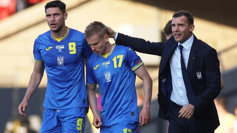 Ukraine's Oleksandr Zinchenko celebrates scoring their first goal with teammate Roman Yaremchuk and coach Andriy Shevchenko