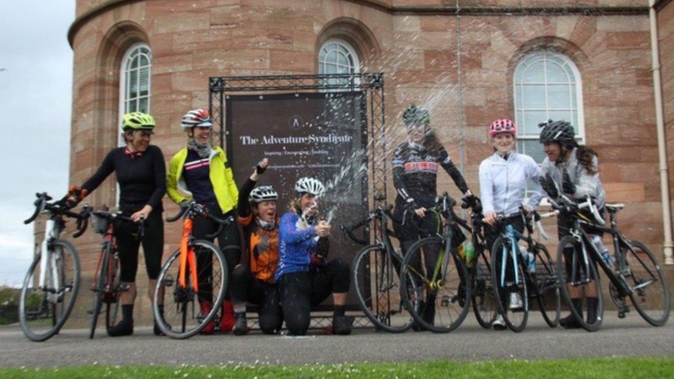 Seven cyclists celebrate completing the NC 500