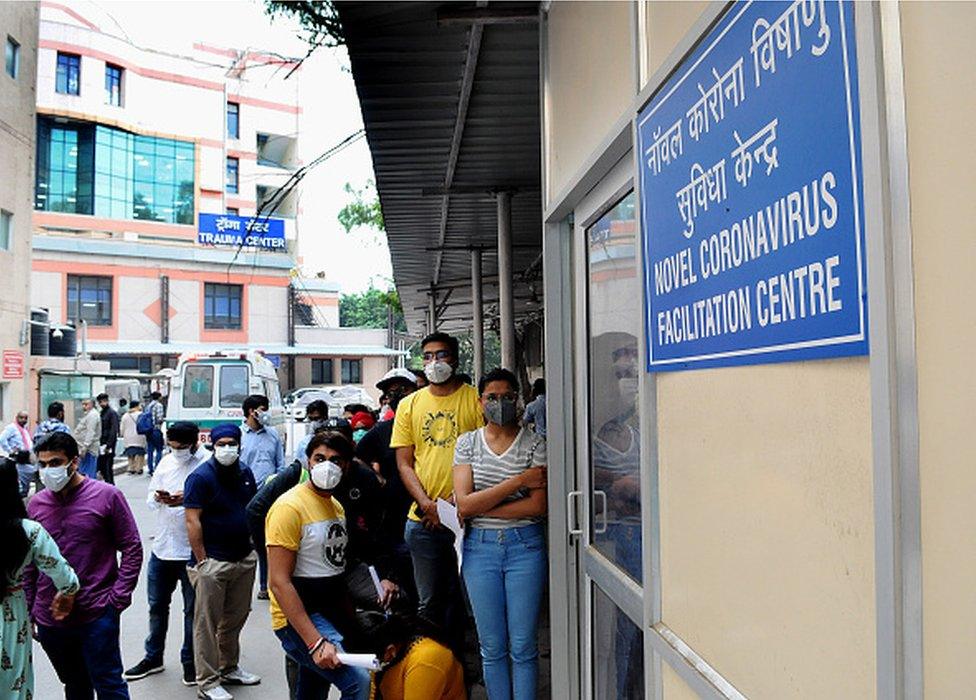 Indian People queue up at a COVID screening center at Ram Manohar Lohia Hospital,(RML) after a case emerged in Delhi causing a panic situation in Delhi India, 04 March 2020.