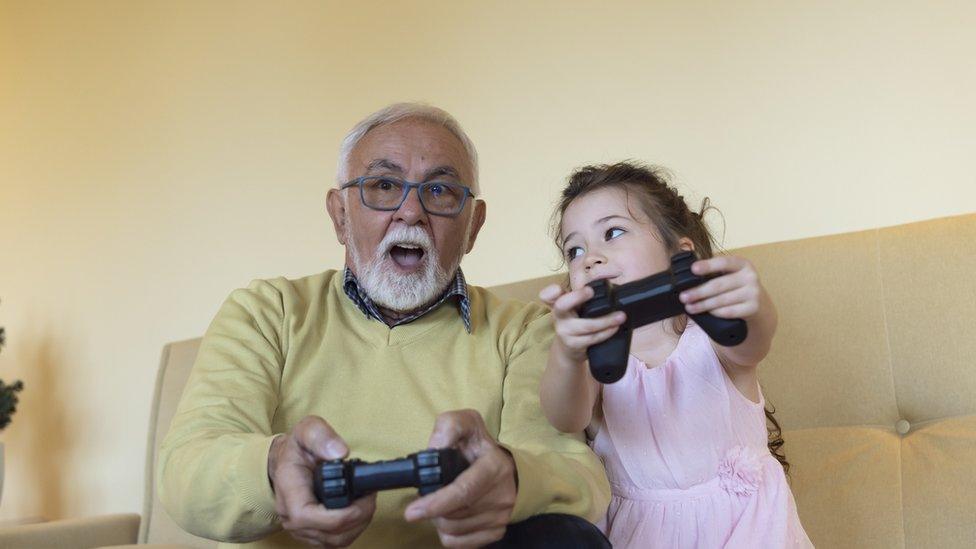 grandfather-playing-games-with-granddaughter-smiling