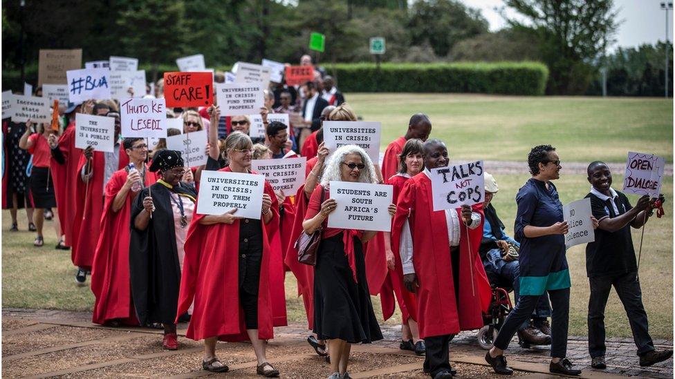 Lecturers and staff of Witwatersrand University demonstrate in support of the free education movement and against violence on campus on September 30, 2016 in Johannesburg.