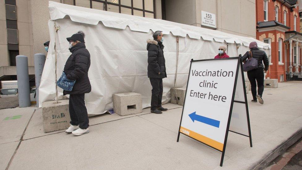 People wait in the line outside the facility. UHN has a Vaccination Pilot injection site set up to administer the COVID-19 vaccine to those ear marked to receive it first.