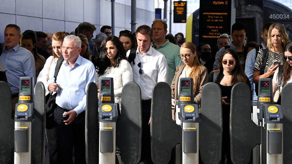 Commuters go through the barriers at Waterloo Station