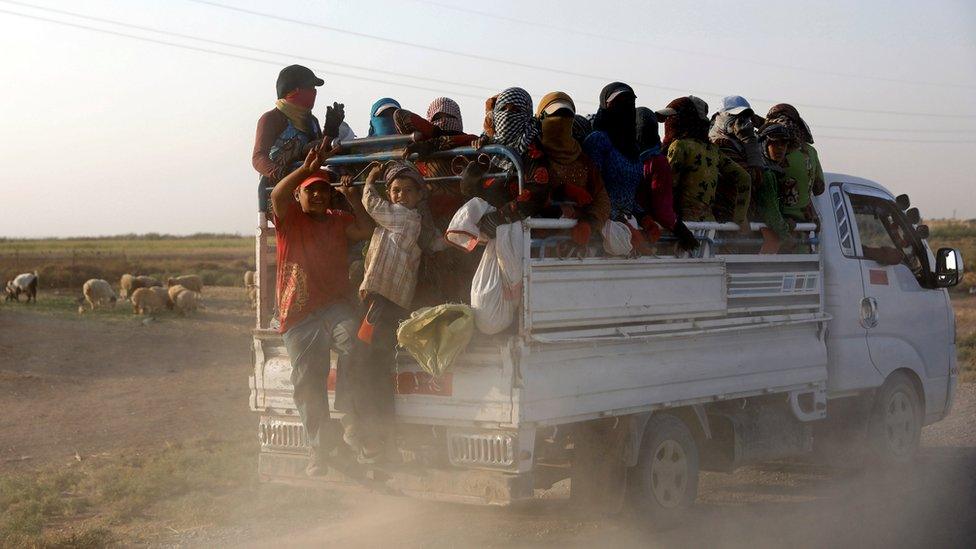 Residents displaced by fighting between Syrian Democratic Forces and Islamic State militants ride on a truck near Raqqa