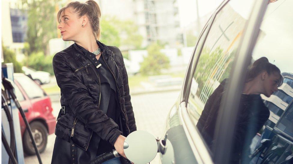 Woman refuelling car