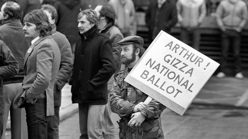 A Leicester miner from the Power Group holds a placard addressed to National Union of Miners President Arthur Scargill, outside the NUM"s Sheffield headquarters when Scargill spoke to the Leicester miners.