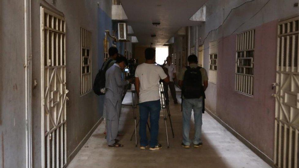 Pakistani journalists stand near a house allegedly belonging to the two men killed in US drone strike in Noshki, in Karachi, Pakistan 23 May 2016.