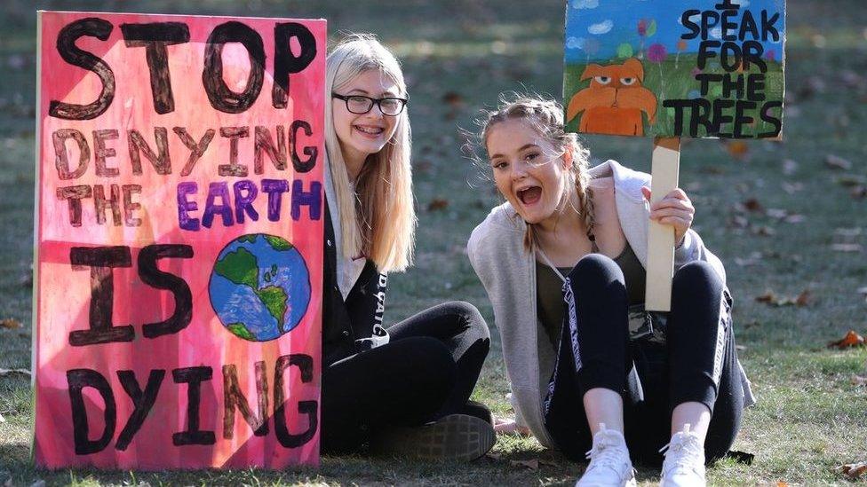 Protesters in London holding placards