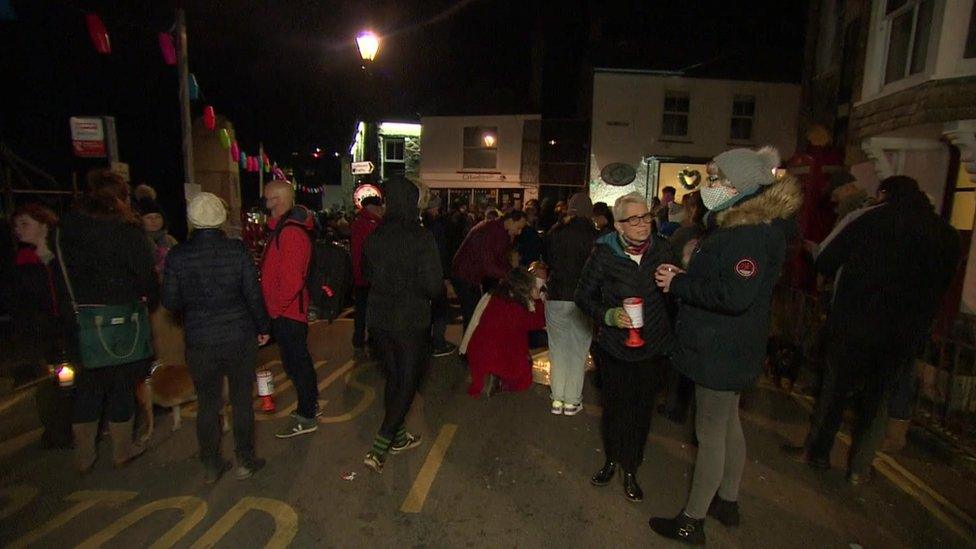 People gathered on the road in Mousehole