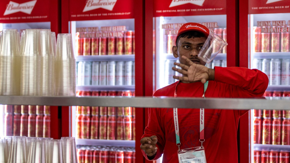 Vendor at a Budweiser kiosk in Qatar