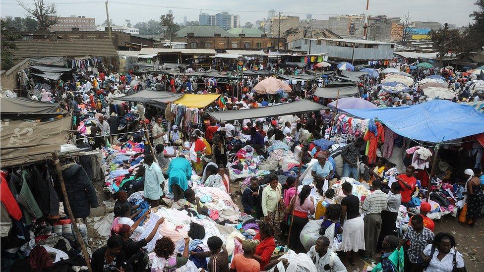 People walk around Gikomba Market, East Africa's biggest second-hand clothing market, on July 10, 2014 in Nairobi.