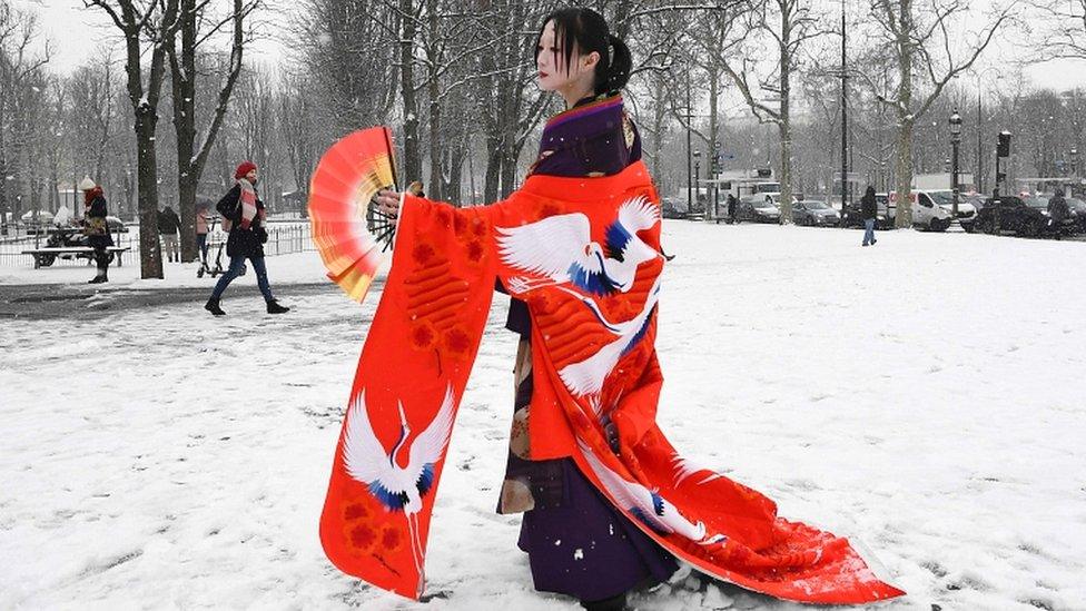 Fashion and costume designer Masami performs under the snow, prior to the Chanel Spring-Summer 2019 haute couture collection fashion show at the Grand Palais in Paris, on 22 January 2019