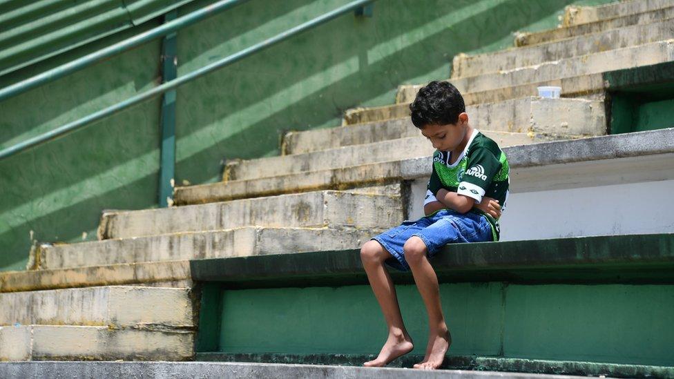 A young boy alone in the stands at Chapecoense Real's stadium in southern Brazil