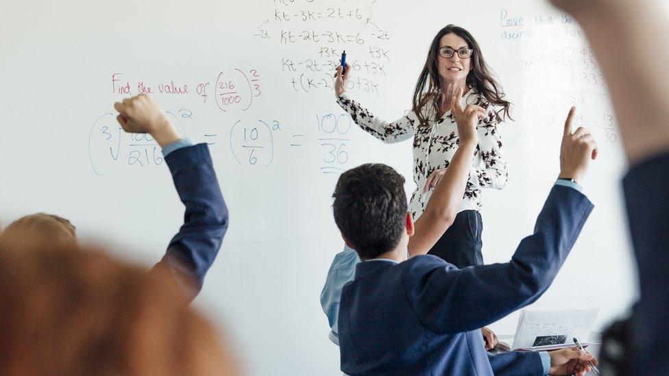 Stock picture of teacher in front of class