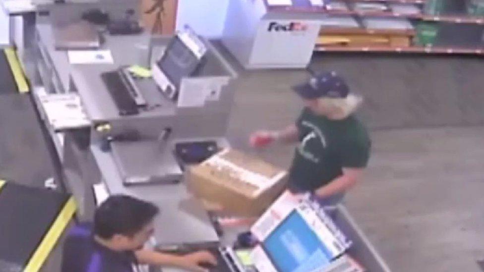 The suspect was pictured dropping off parcel bombs at a FedEx store