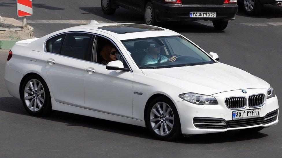 A bright white modern-looking BMW with an Iranian licence plate