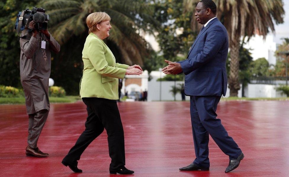 Senegal President Macky Sall greets German leader Angela Merkel in Dakar, Senegal - Wednesday 29 August 2018