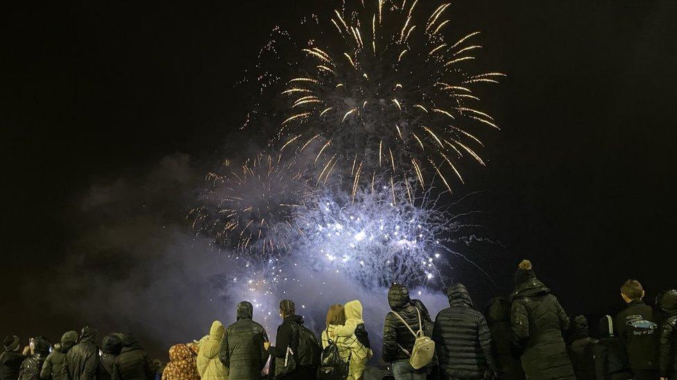 People watching Halloween fireworks go off in Derry